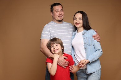 Photo of Portrait of happy family on brown background, space for text