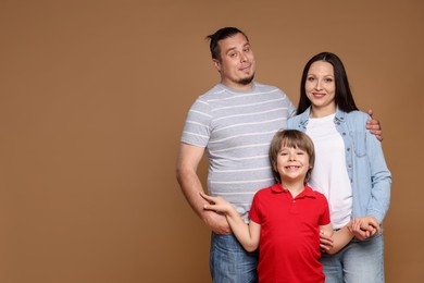 Photo of Portrait of happy family on brown background, space for text