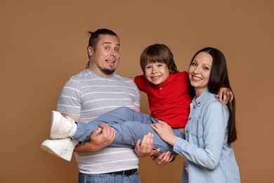 Photo of Portrait of happy family on brown background