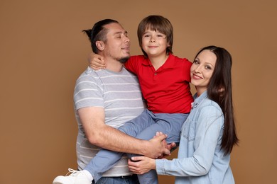 Photo of Portrait of happy family on brown background