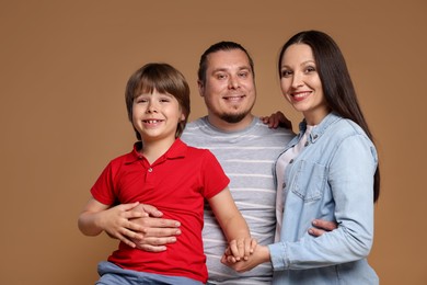Photo of Portrait of happy family on brown background