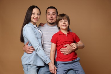 Photo of Portrait of happy family on brown background