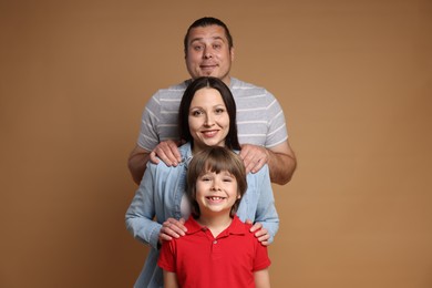 Photo of Portrait of happy family on brown background
