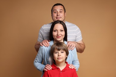 Photo of Portrait of happy family on brown background