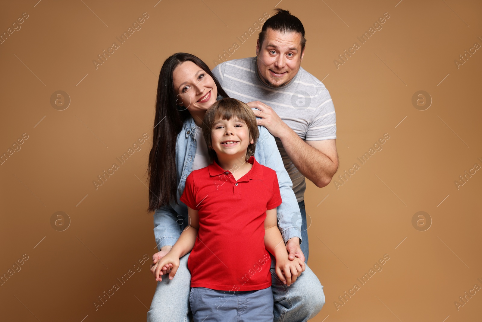 Portrait of happy family on brown background Photo of Portrait of happy family on brown background