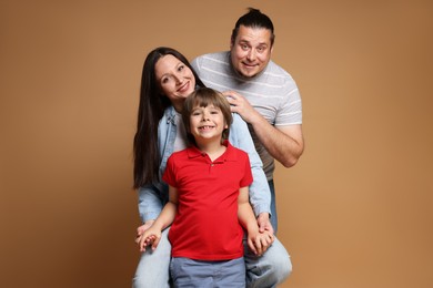 Photo of Portrait of happy family on brown background