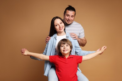 Photo of Portrait of happy family on brown background