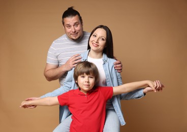 Photo of Portrait of happy family on brown background
