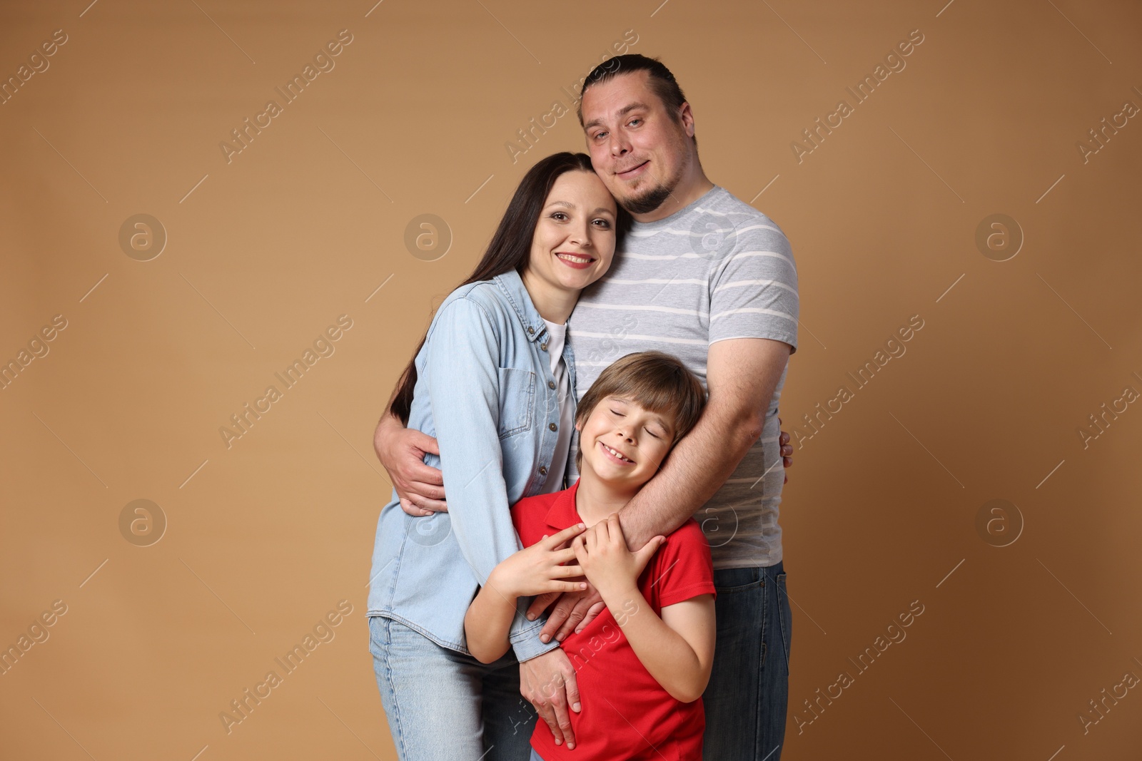 Portrait of happy family on brown background Photo of Portrait of happy family on brown background