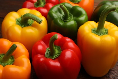 Photo of Fresh colorful bell peppers on table, closeup