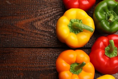 Photo of Fresh colorful bell peppers on wooden table, flat lay. Space for text