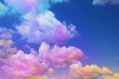 Image of Fluffy color clouds floating in beautiful blue sky