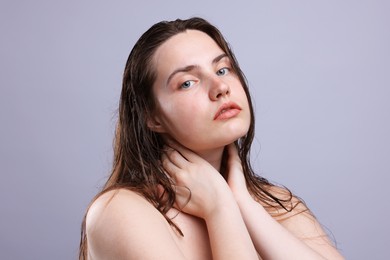 Photo of Portrait of woman with natural skin complexion on grey background, closeup