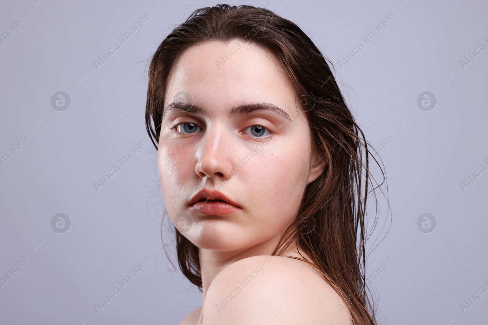 Portrait of woman with natural skin complexion on grey background, closeup Photo of Portrait of woman with natural skin complexion on grey background, closeup