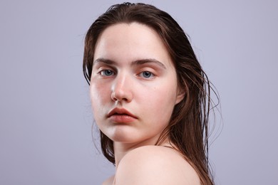 Photo of Portrait of woman with natural skin complexion on grey background, closeup