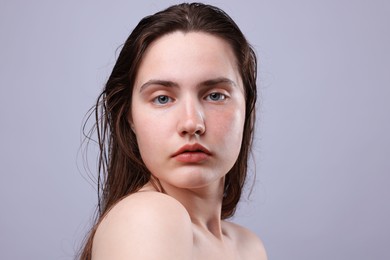 Photo of Portrait of woman with natural skin complexion on grey background, closeup