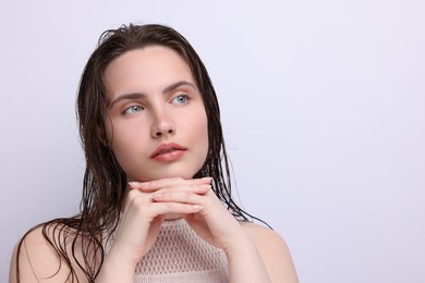 Photo of Beautiful woman with natural skin complexion on light grey background, closeup. Space for text
