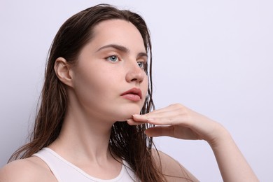 Photo of Beautiful woman with natural skin complexion on light grey background, closeup