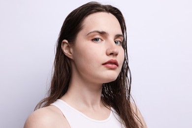 Photo of Portrait of beautiful woman with natural skin complexion on light grey background, closeup