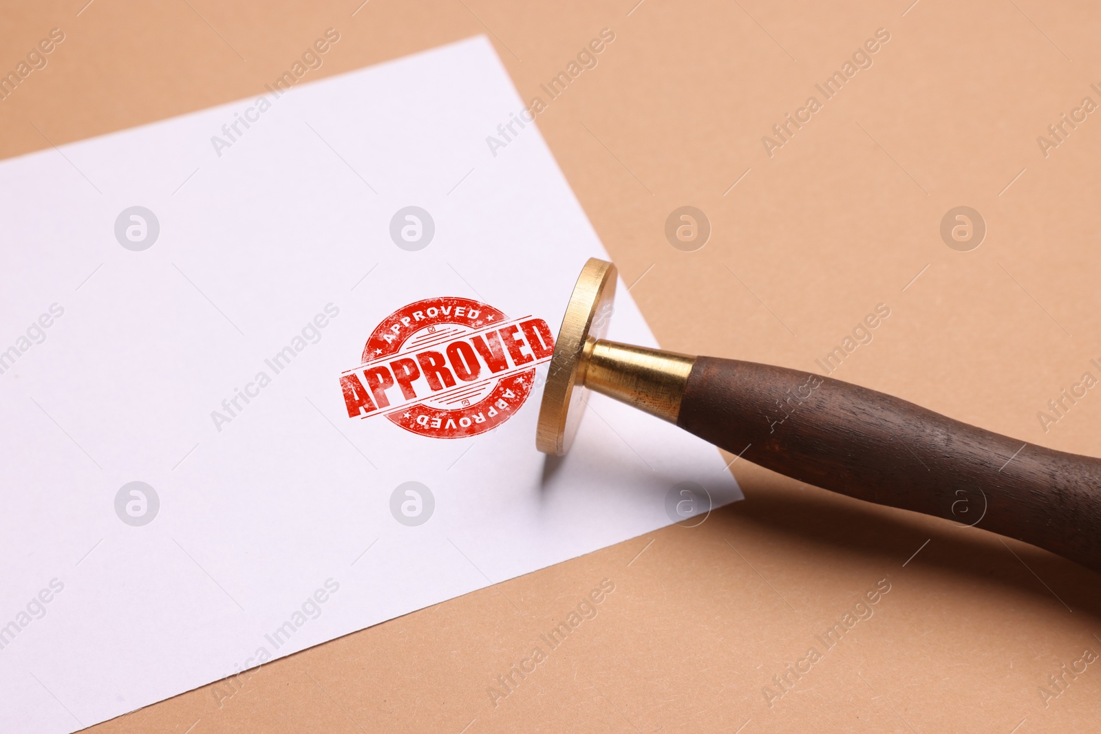 Sheet of paper with red stamp Approved and stamp on pale brown background Image of Sheet of paper with red stamp Approved and stamp on pale brown background