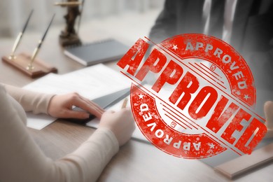Image of Woman signing document at table in office and red stamp Approved