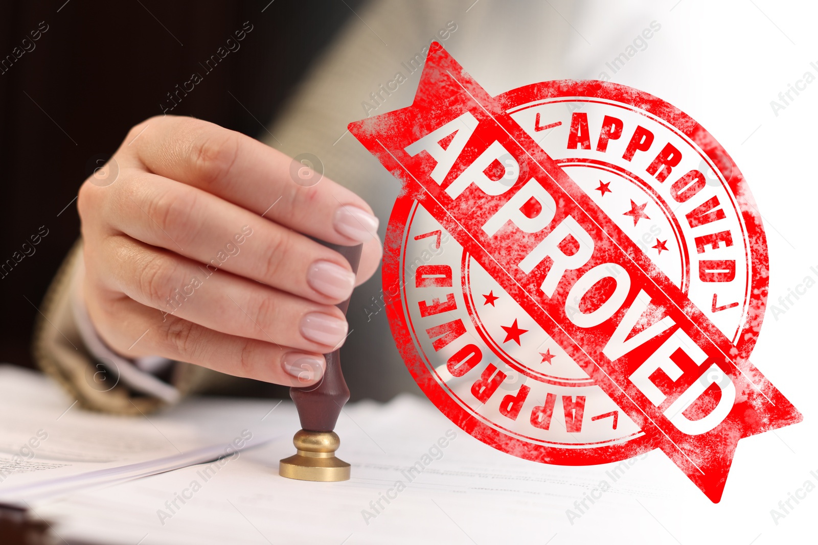 Woman stamping document at table and red stamp Approved Image of Woman stamping document at table and red stamp Approved