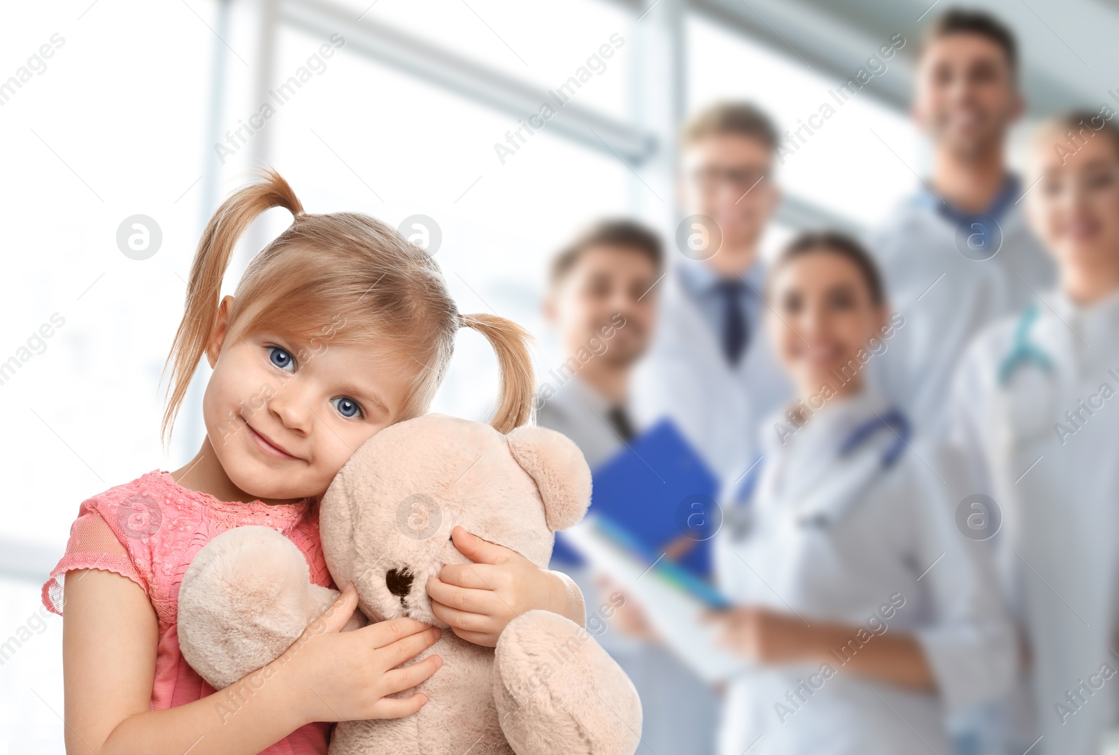 Cute child holding toy bear and medical staff in hospital. Pediatric ward Image of Cute child holding toy bear and medical staff in hospital. Pediatric ward