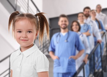 Image of Cute child and medical staff in hospital. Pediatric ward