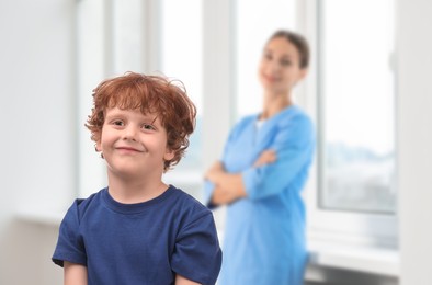 Image of Cute child and doctor in hospital. Pediatric ward
