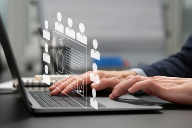 Image of Human resources manager working on laptop at table, closeup. Candidate's resume on virtual screen above computer. Recruitment and employee search