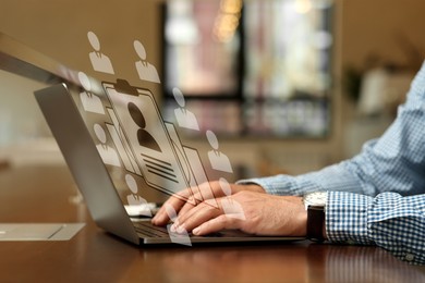 Image of Human resources manager working on laptop at table, closeup. Candidate's resume on virtual screen above computer. Recruitment and employee search