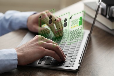 Image of Human resources manager searching for employee on laptop at table, closeup. Resumes on virtual screen above computer. Recruitment