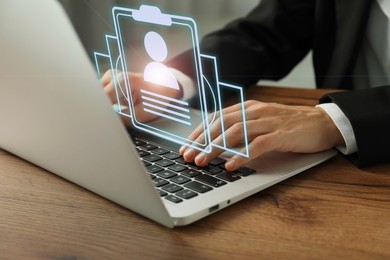 Image of Human resources manager working on laptop at table, closeup. Candidate's resume on virtual screen above computer. Recruitment and employee search