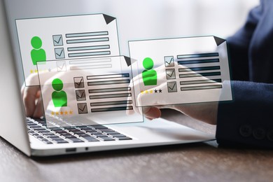 Image of Human resources manager searching for employee on laptop at table, closeup. Resumes on virtual screen above computer. Recruitment