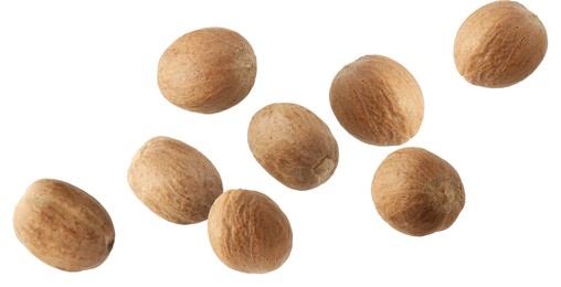 Image of Aromatic nutmeg seeds falling on white background