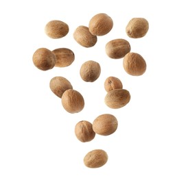 Image of Aromatic nutmeg seeds falling on white background