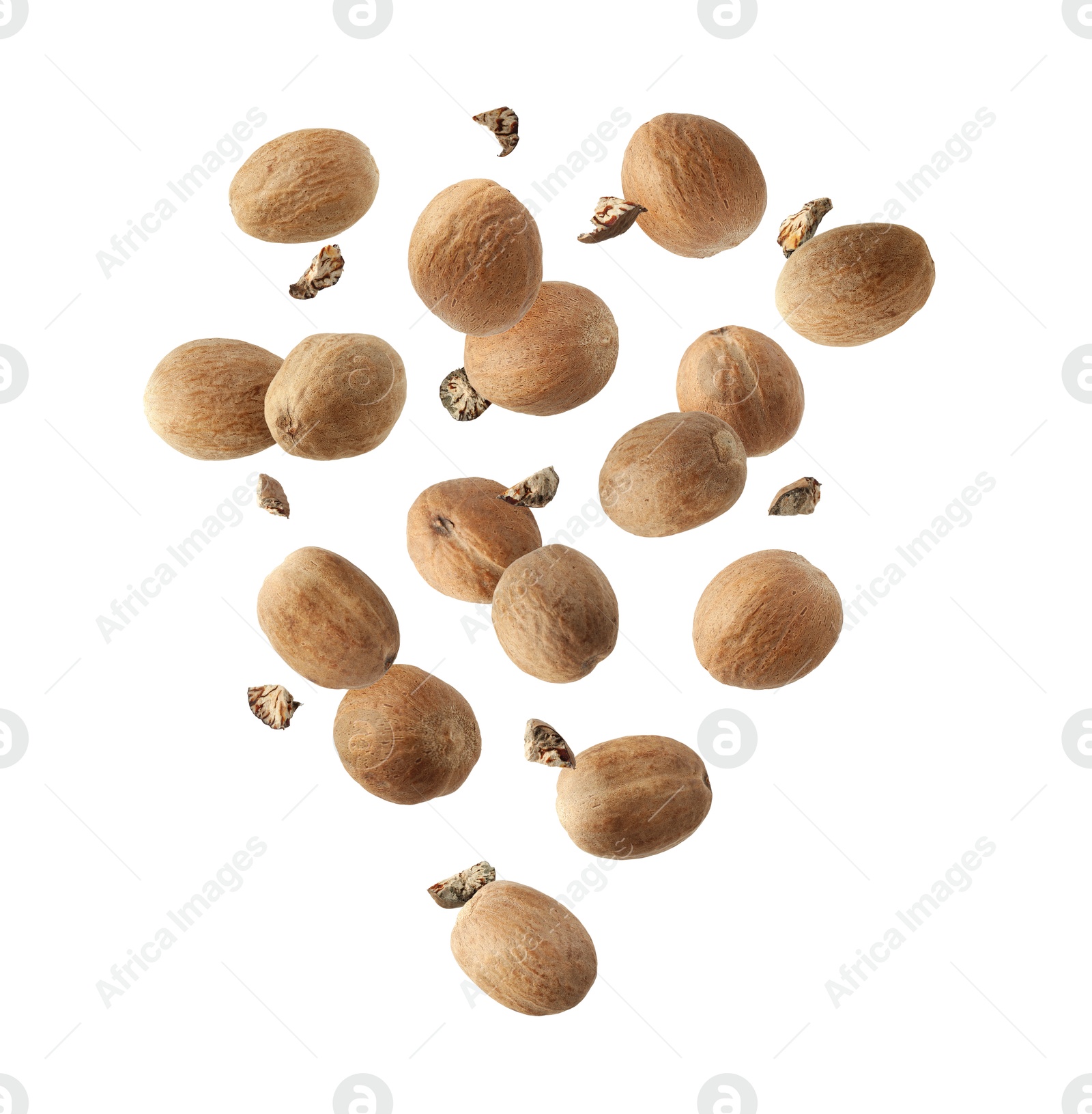 Image of Aromatic nutmeg seeds and pieces falling on white background