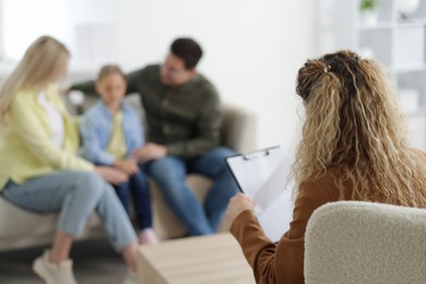 Photo of Family having consultation with psychologist in office, selective focus