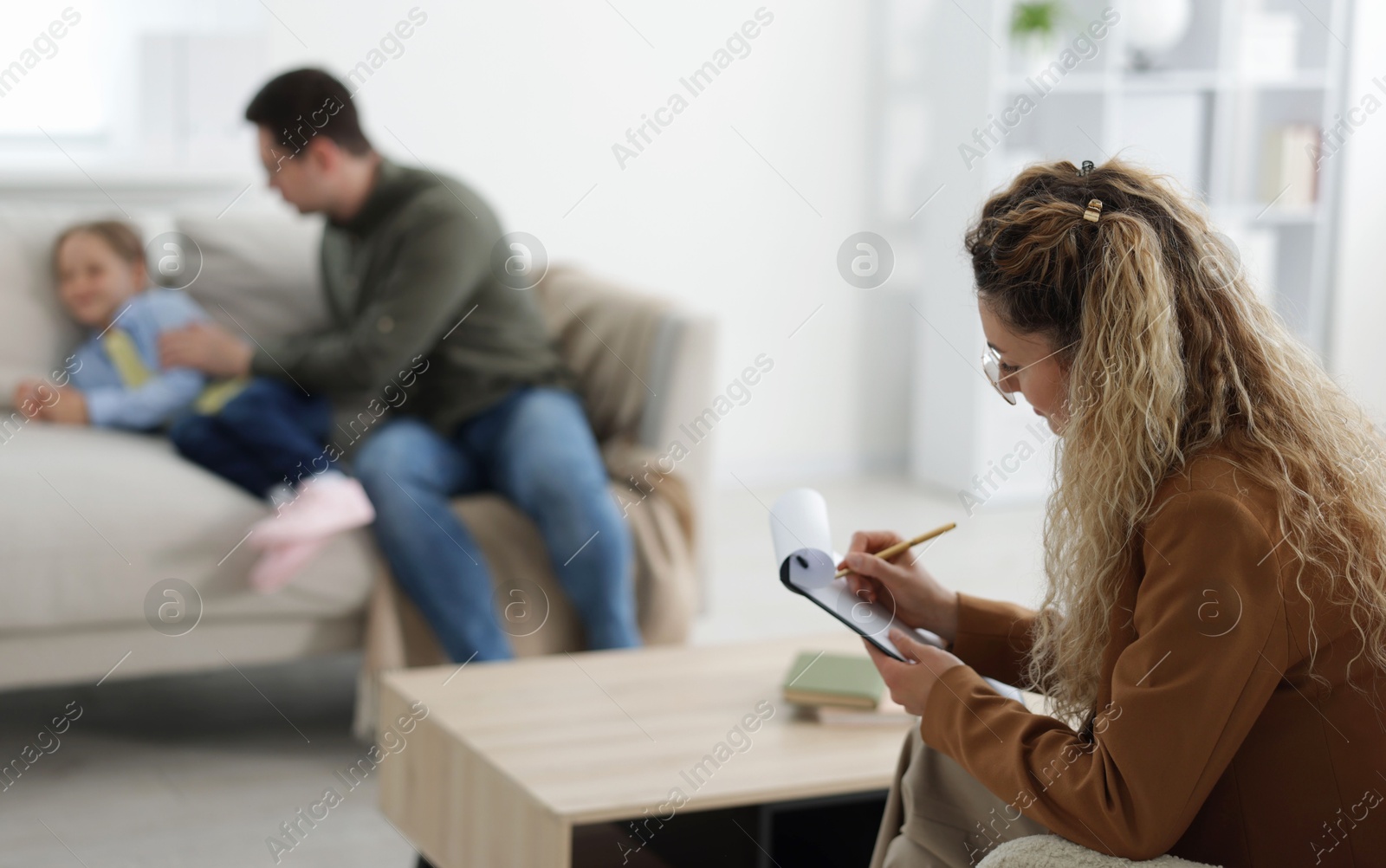 Father and daughter having consultation with psychologist in office, selective focus Photo of Father and daughter having consultation with psychologist in office, selective focus