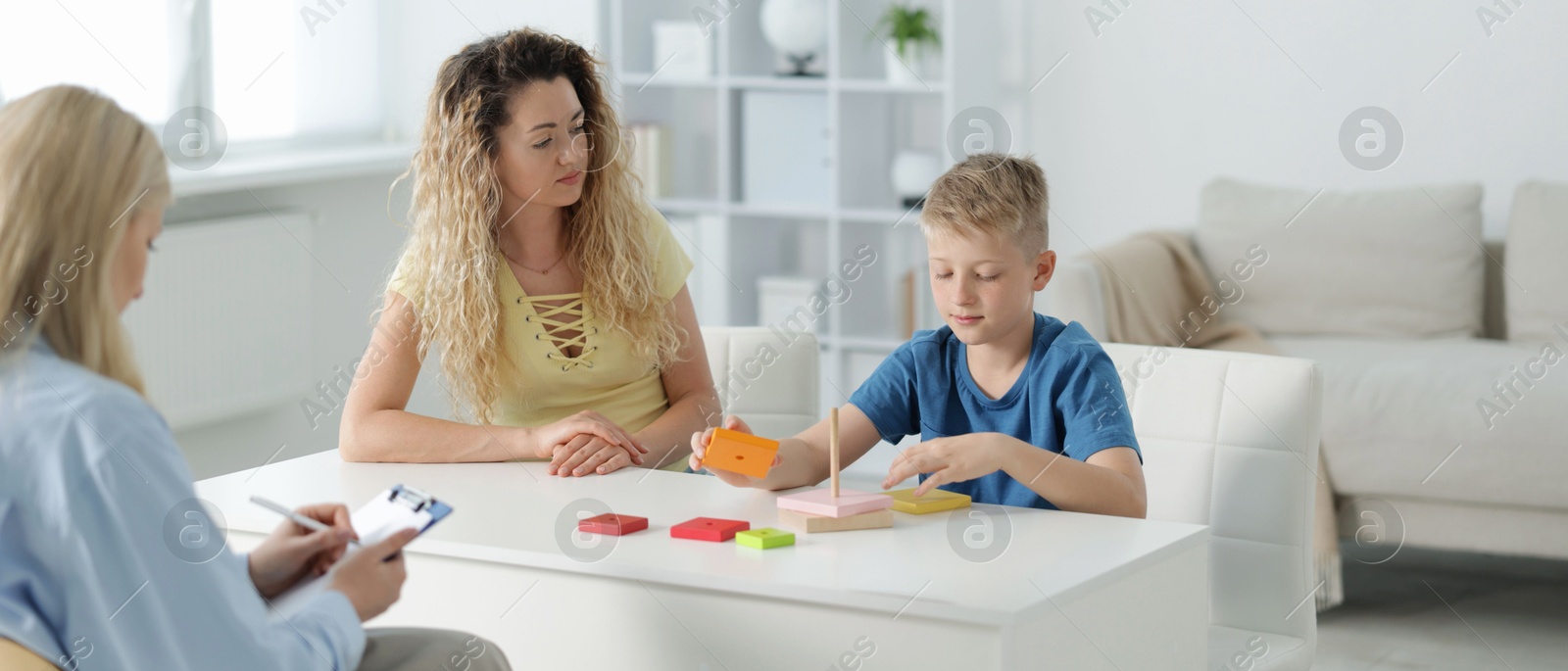 Mother and son having consultation with psychologist in office, selective focus Photo of Mother and son having consultation with psychologist in office, selective focus