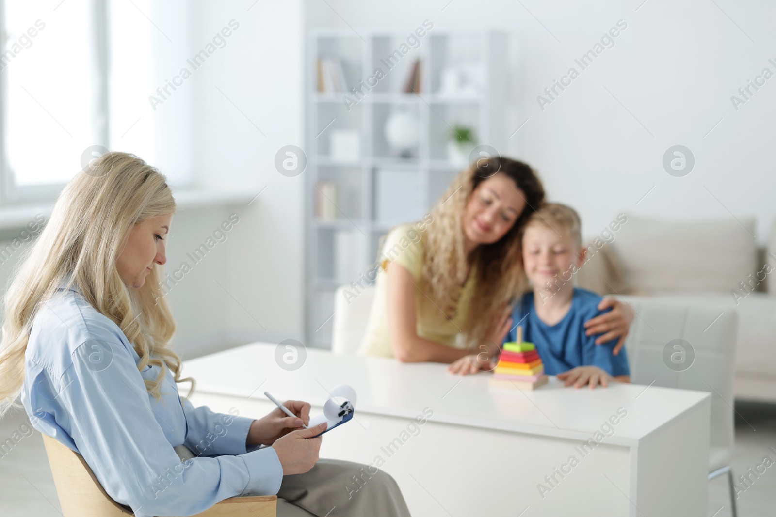Mother and son having consultation with psychologist in office, selective focus Photo of Mother and son having consultation with psychologist in office, selective focus
