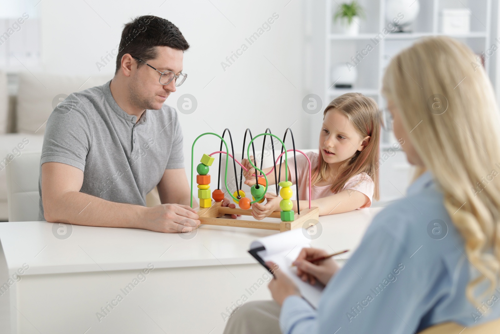 Father and daughter having consultation with psychologist in office, selective focus Photo of Father and daughter having consultation with psychologist in office, selective focus
