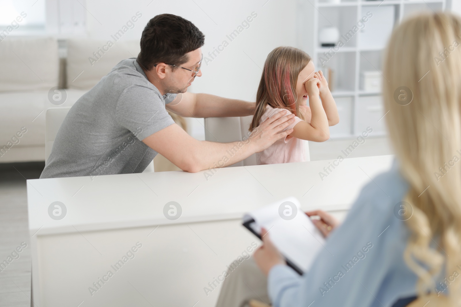 Father and daughter having consultation with psychologist in office, selective focus Photo of Father and daughter having consultation with psychologist in office, selective focus