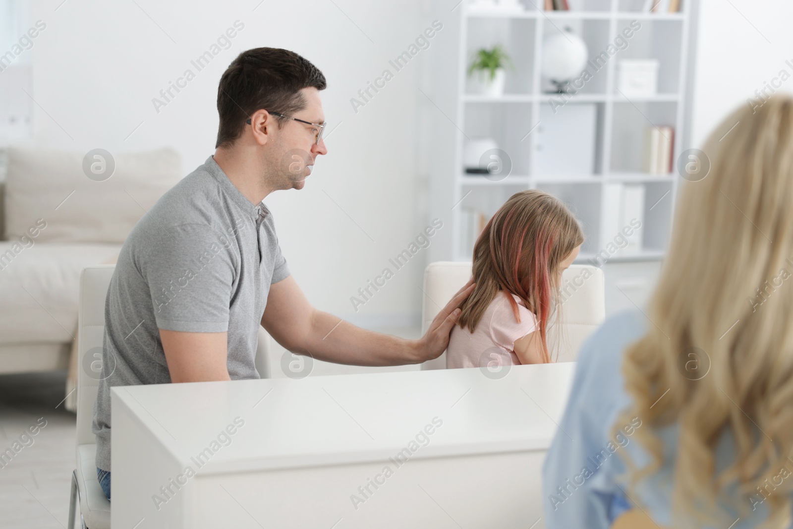 Father and daughter having consultation with psychologist in office, selective focus Photo of Father and daughter having consultation with psychologist in office, selective focus