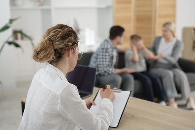 Photo of Family psychologist working in office, selective focus
