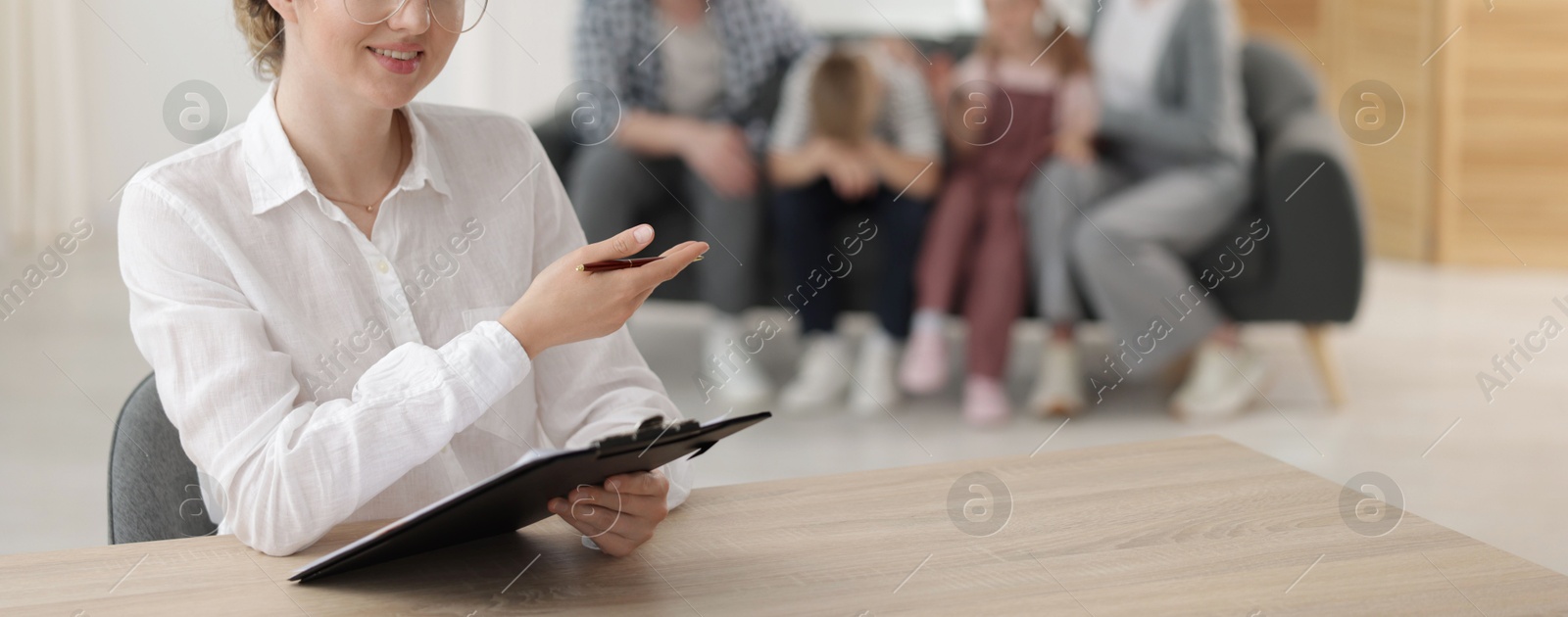 Smiling family psychologist working in office, selective focus Photo of Smiling family psychologist working in office, selective focus