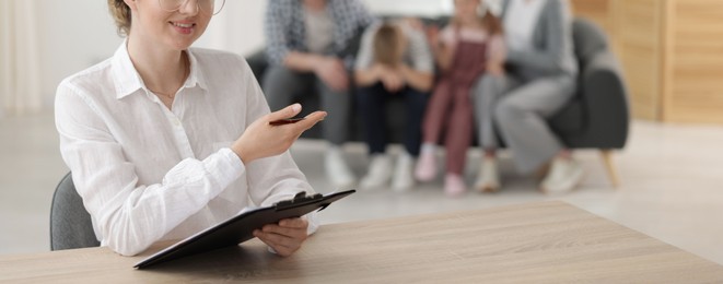 Photo of Smiling family psychologist working in office, selective focus
