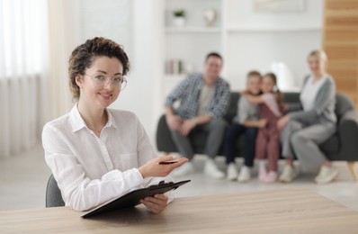 Photo of Smiling family psychologist working in office, selective focus