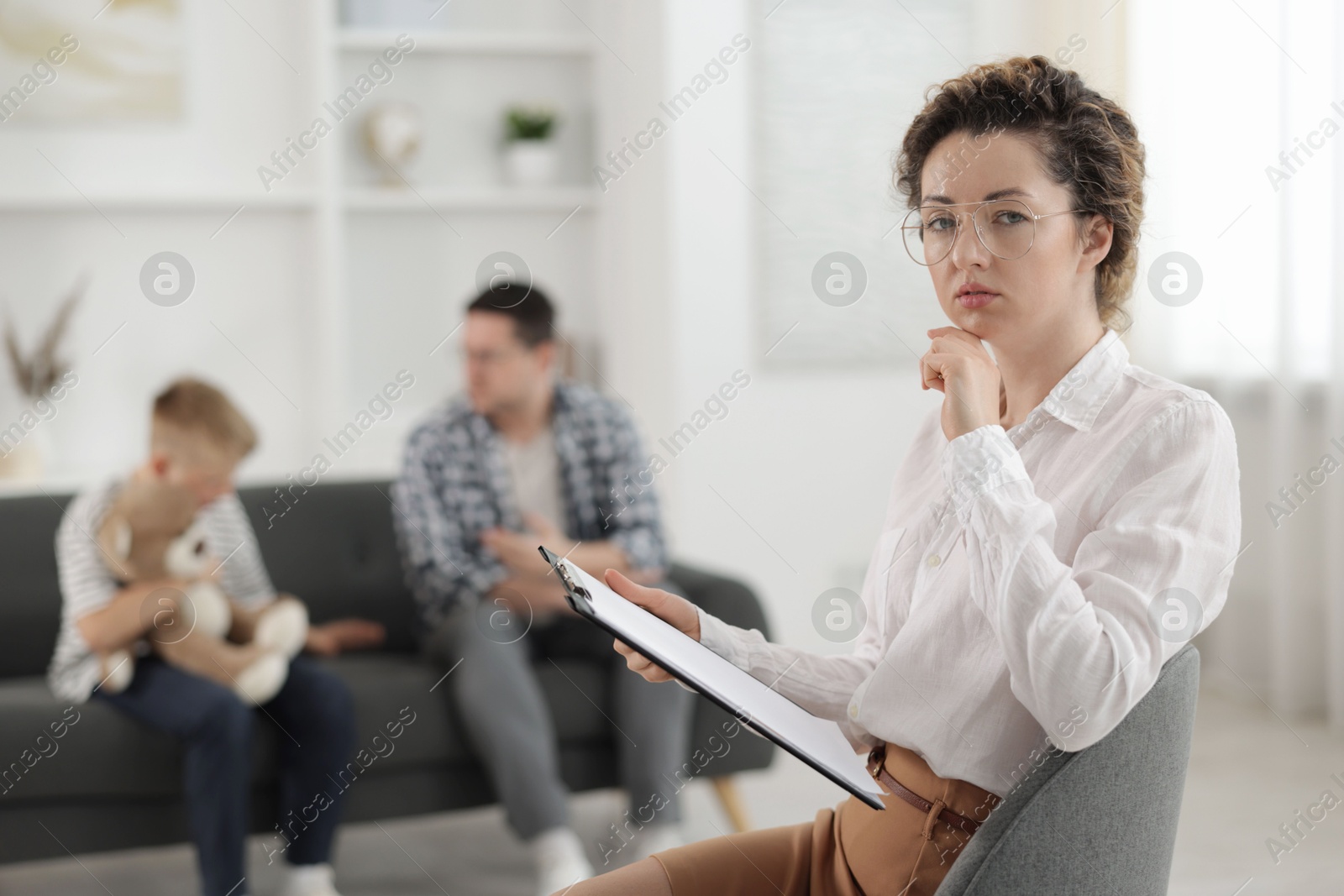 Father and son having consultation with psychologist in office, selective focus Photo of Father and son having consultation with psychologist in office, selective focus