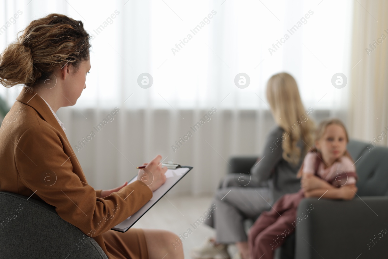 Mother and daughter having consultation with psychologist in office, selective focus Photo of Mother and daughter having consultation with psychologist in office, selective focus